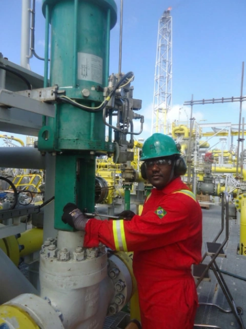 Technician performing antisurge valve maintenance on an FPSO site