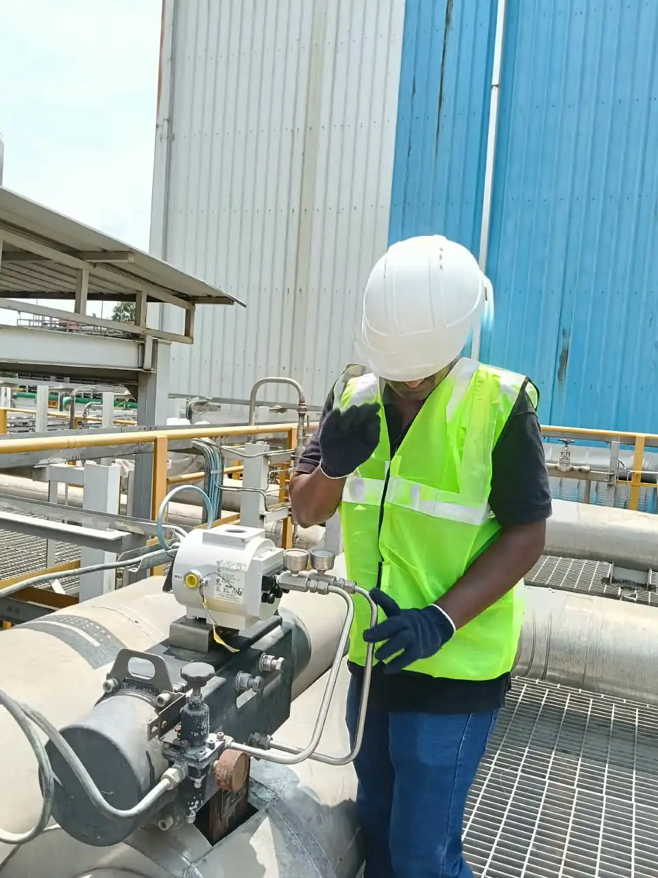 Technician troubleshooting a critical rotary control valve onsite