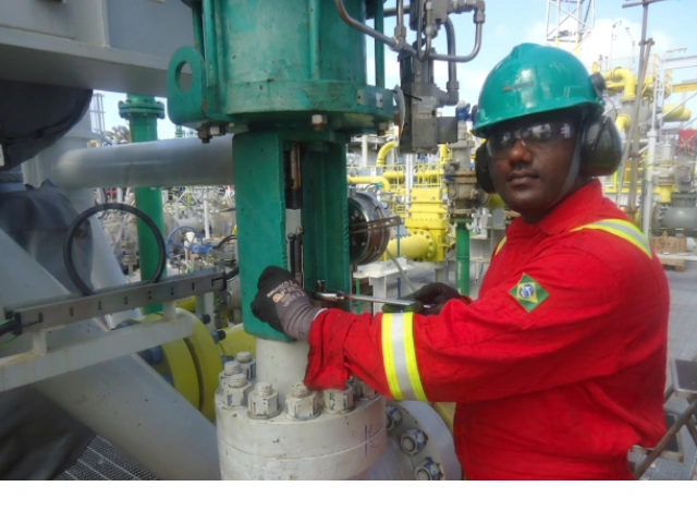 Technician mounting a piston actuator on an FPSO platform