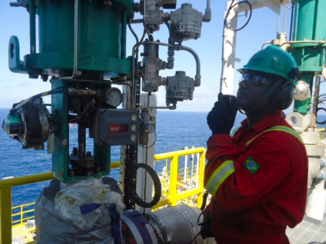 Technician performing reactive maintenance on a severe service antisurge valve